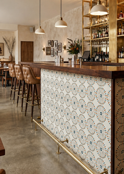 Atomic Vocho Papaya Pattern Tile by Clay Imports, featuring radial designs in teal and orange on a cream background, adorning a bar counter.