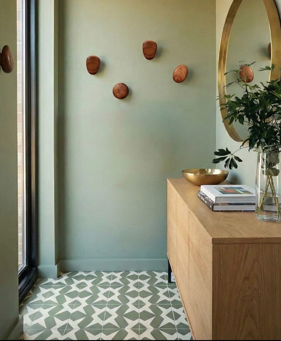 Green and white pattern tile by Clay Imports with a geometric star-like design on an entryway floor.