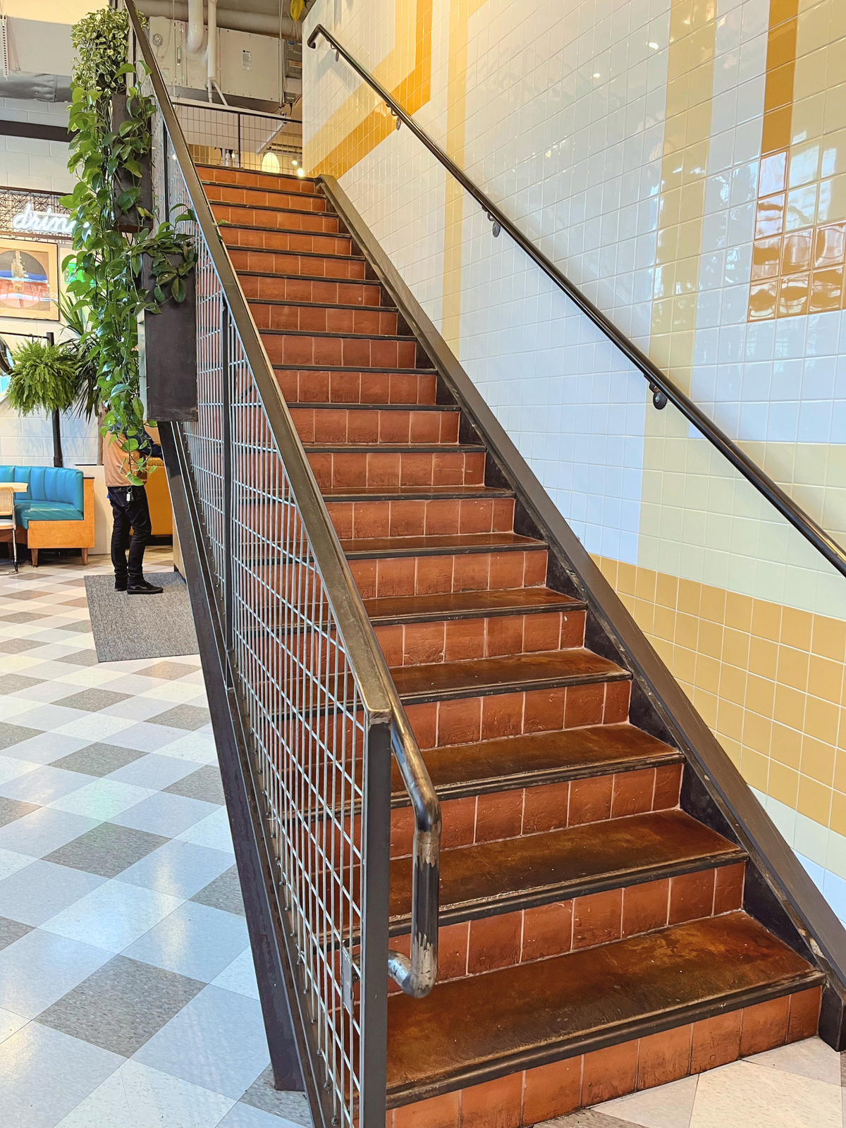 Terracotta 6x6 Antique Satin tiles by Clay Imports, forming a rustic staircase with dark nosings and metal railings.