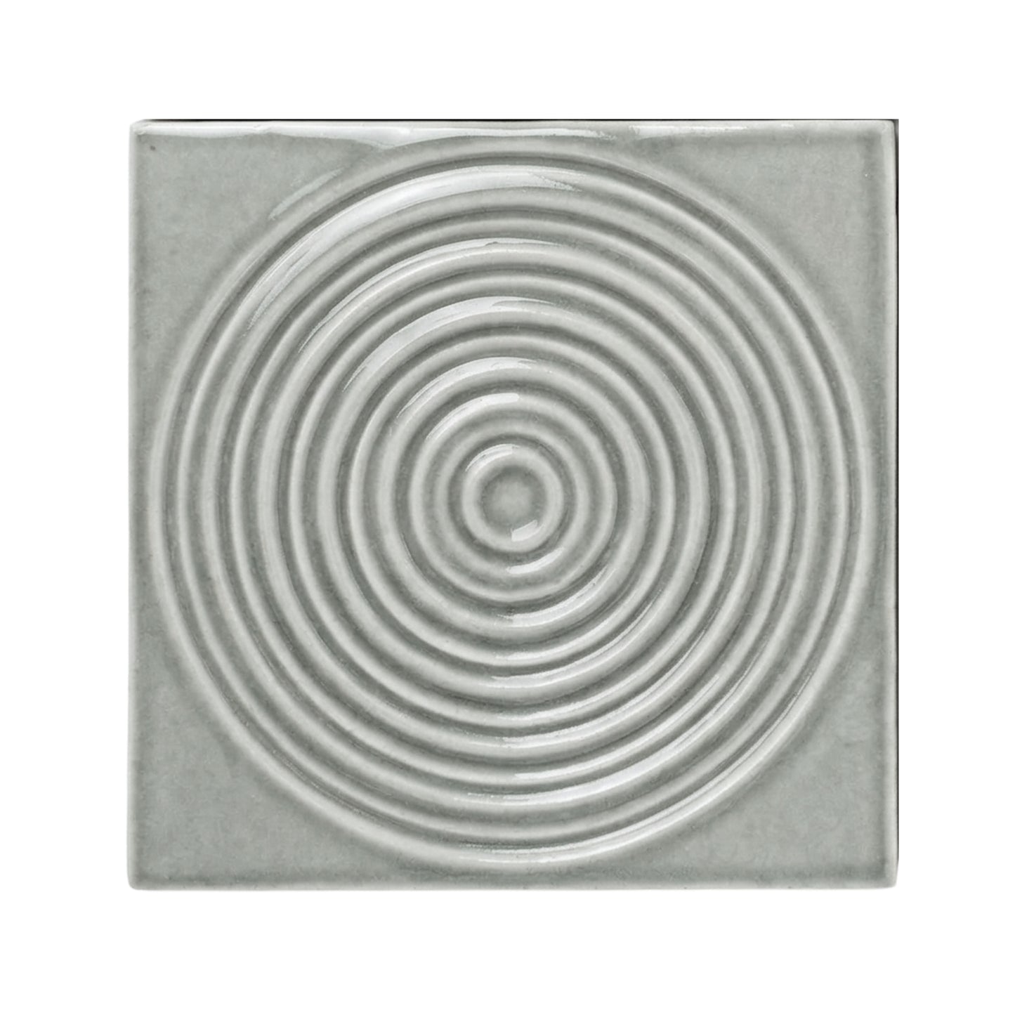 Arctic grey sample tile by Clay Imports with raised concentric circles and a glossy finish.