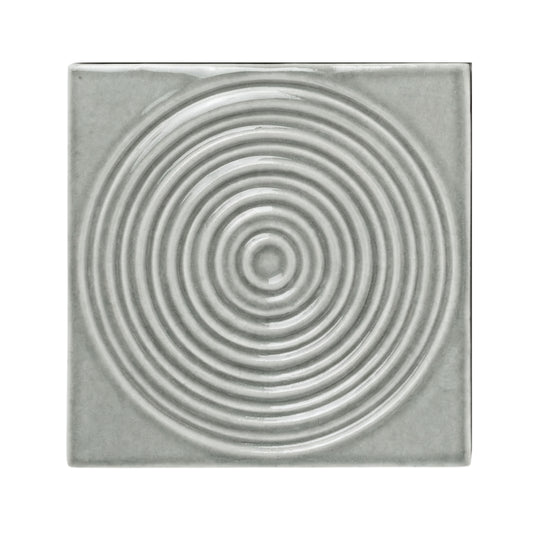 Arctic grey sample tile by Clay Imports with raised concentric circles and a glossy finish.