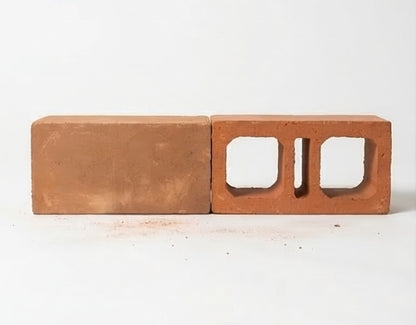 Reddish-brown terracotta paver by Clay Imports, shown side-by-side as a solid rectangular brick and a hollow block.
