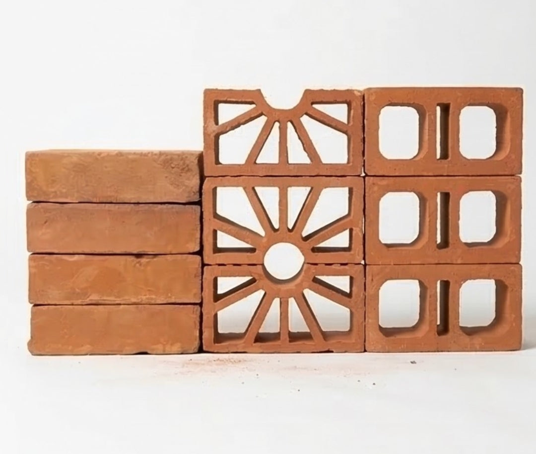 Baked terracotta paver by Clay Imports, reddish-brown, stacked with solid, sunburst, and square-hole cutouts.