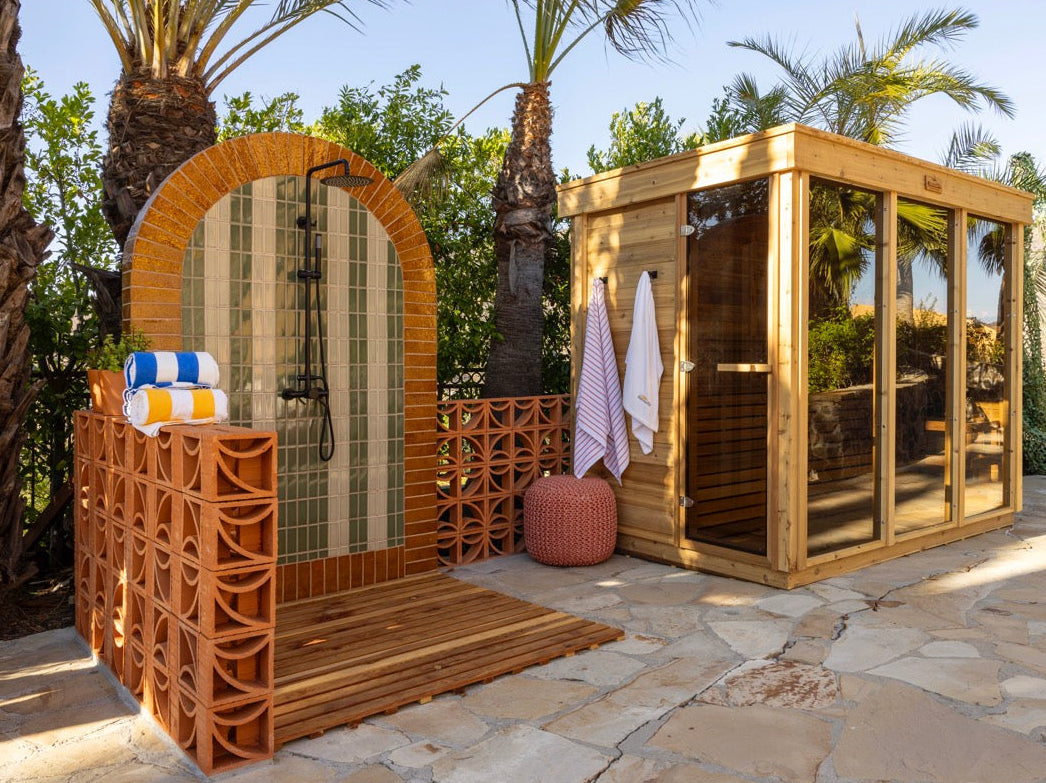 Terra cotta Breeze Block by Clay Imports forming an outdoor shower wall and partition with a curved design.