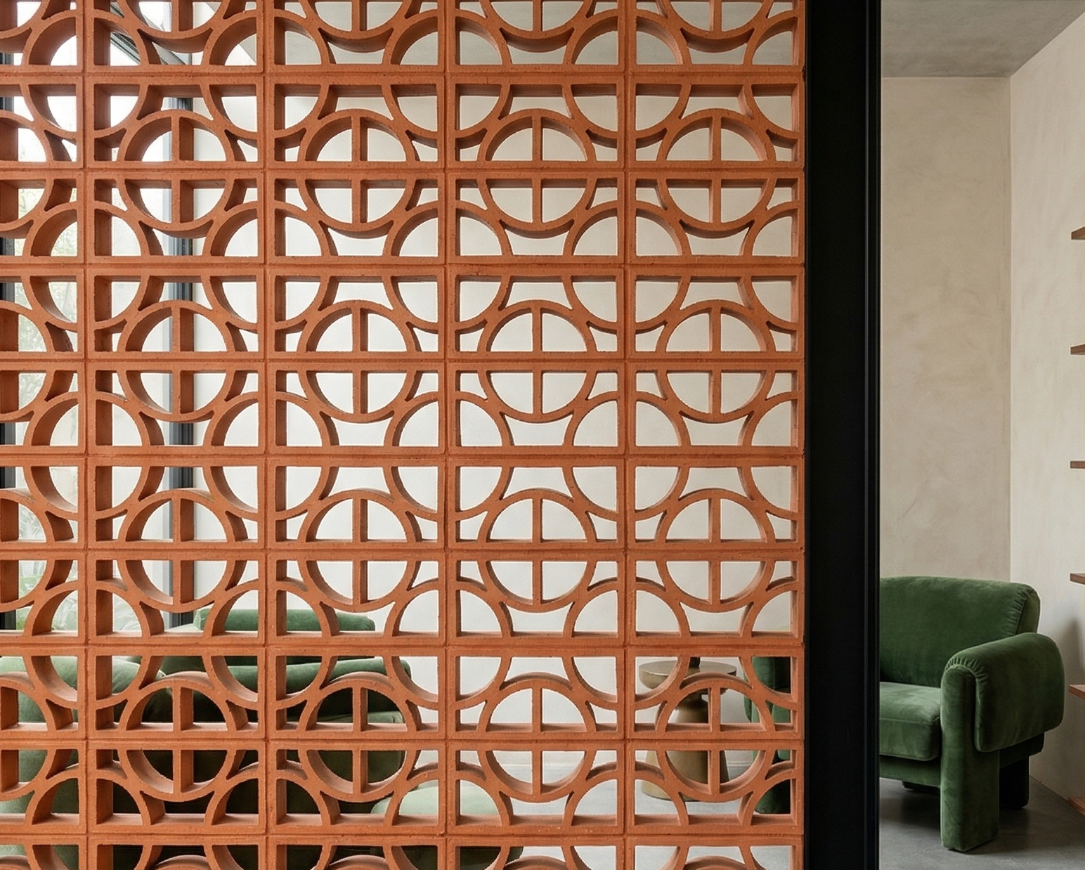 Terracotta breeze block from Clay Imports Breeze Blocks featuring a geometric pattern of semicircles, creating a decorative room divider.