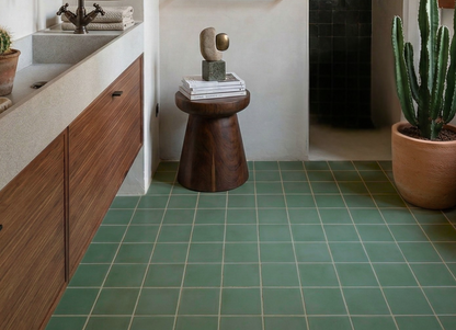Green 6x6 clay tiles by Clay Imports, laid with light grout lines on a bathroom floor.