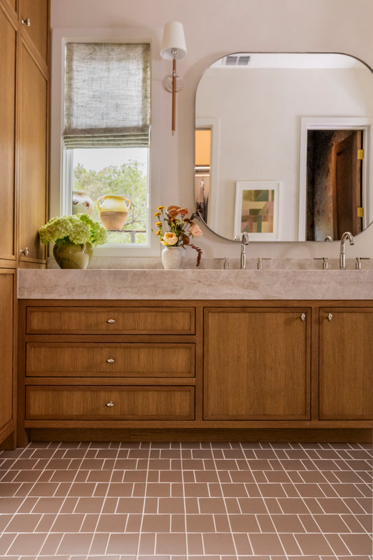 Coyote matte rectangular solid tiles by Clay Imports, laid in an irregular pattern with white grout on a bathroom floor.