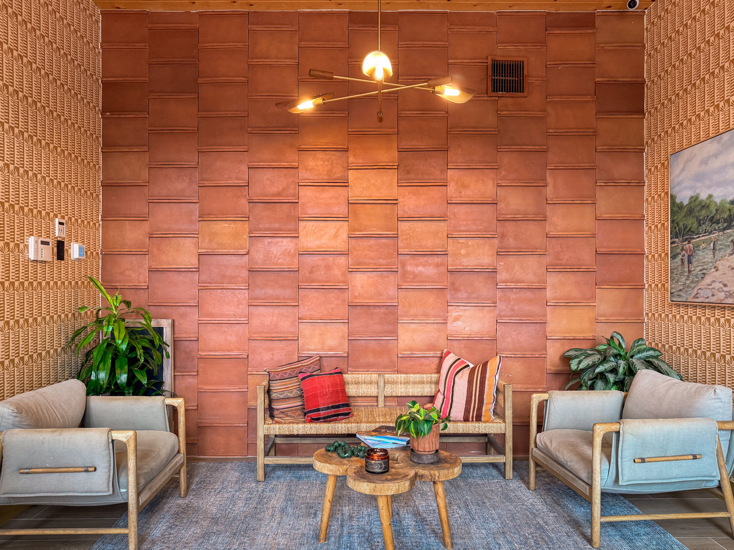 Reddish-brown terracotta tiles with an antique satin finish by Clay Imports, arranged in a staggered pattern on a wall.