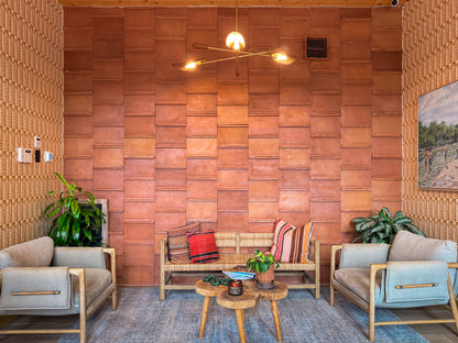 Reddish-brown terracotta tiles with an antique satin finish by Clay Imports, arranged in a staggered pattern on a wall.