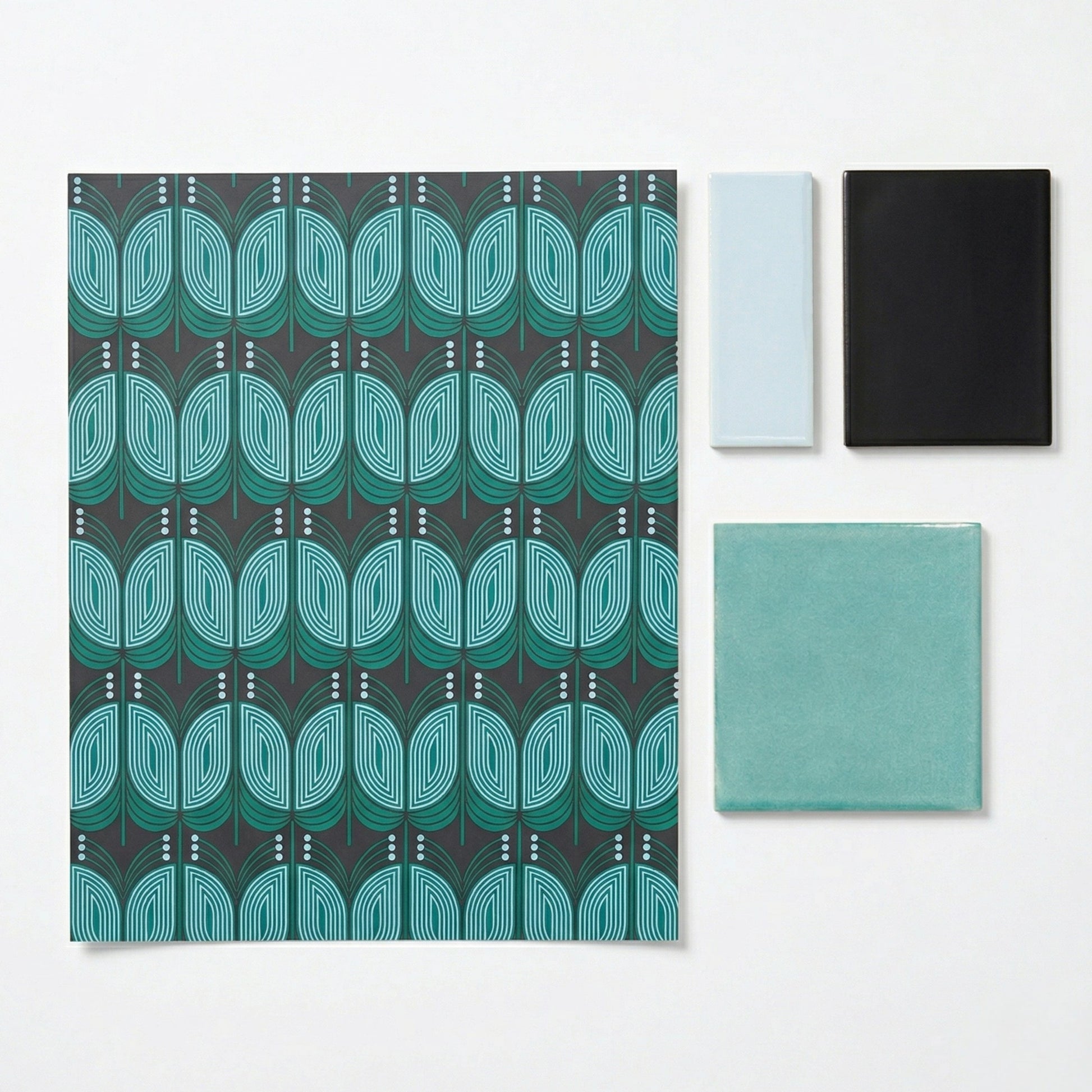 Deco Tide patterned sample in teal and dark grey by Clay Imports, featuring stylized leaves and three solid color tile samples.