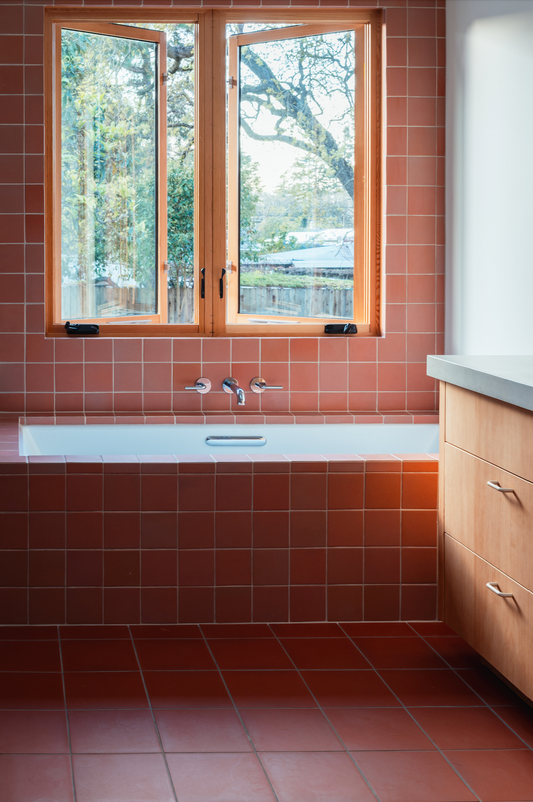Dolores Dust 4.25x4.25 square clay tile by Clay Imports, covering a bathroom's walls and floor.