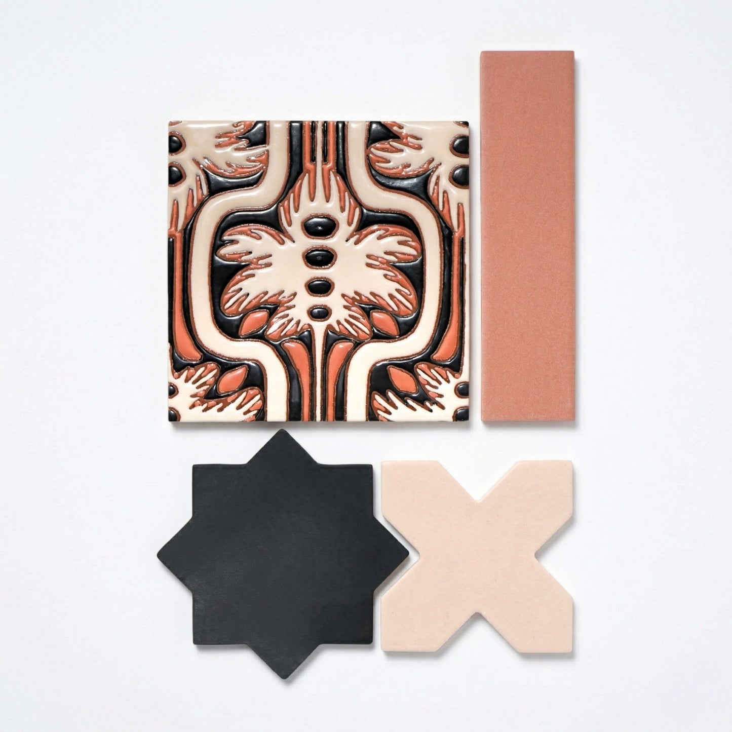 Assorted ceramic tile samples from Clay Imports, featuring a patterned square, a plain terracotta rectangle, a black star, and a beige X-shape.