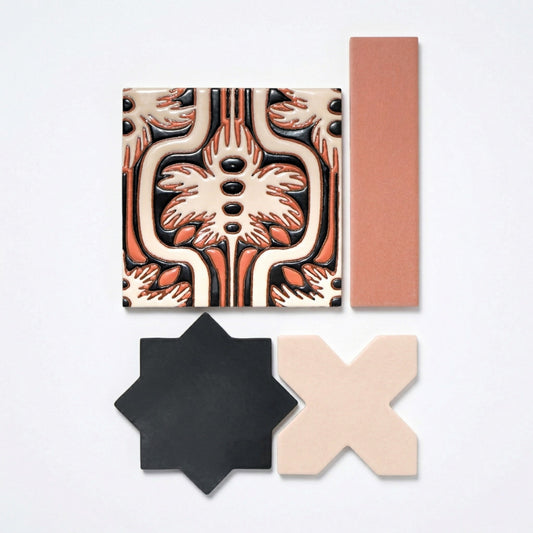 Assorted ceramic tile samples from Clay Imports, featuring a patterned square, a plain terracotta rectangle, a black star, and a beige X-shape.