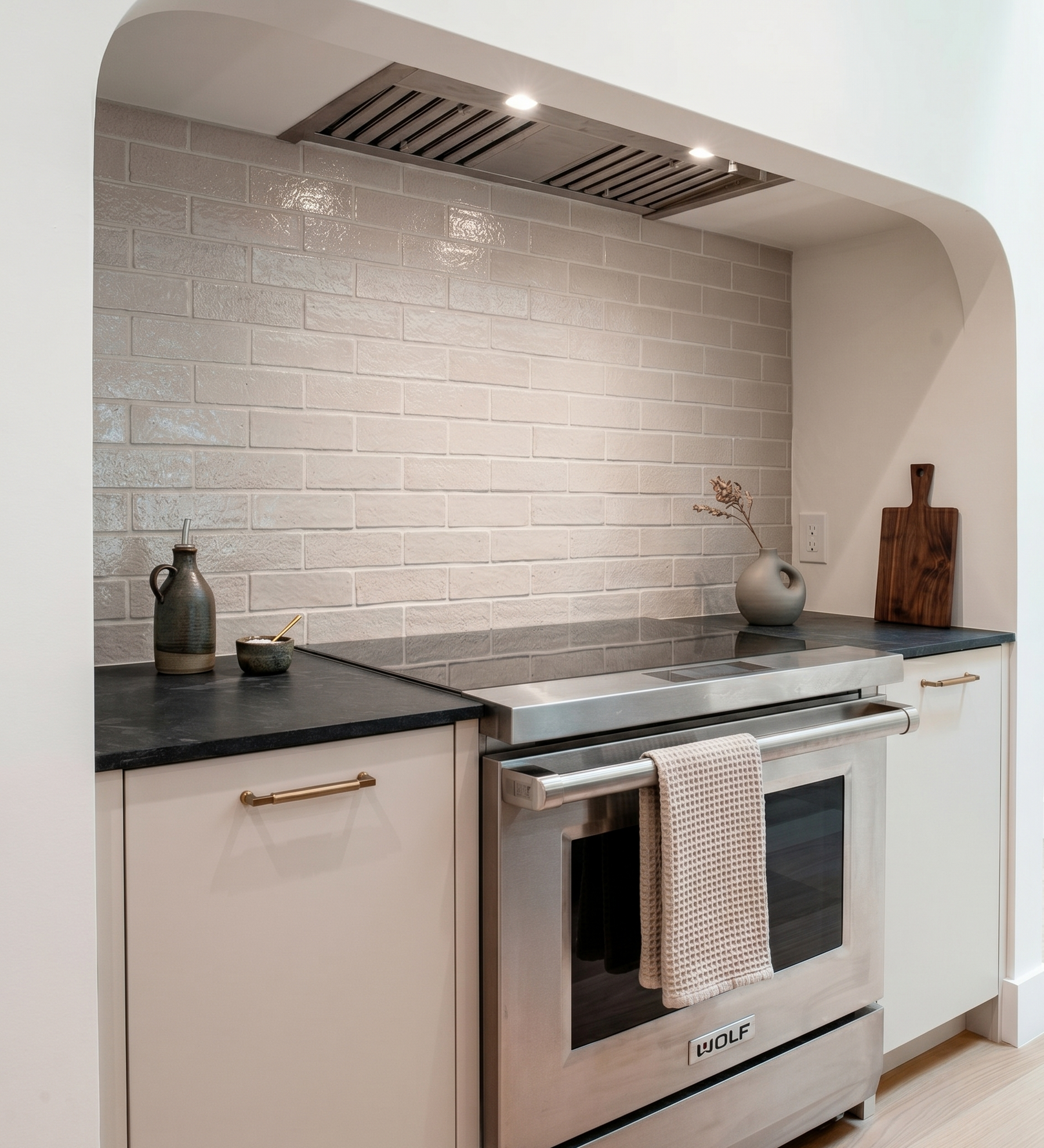 Light tan glazed thin brick by Clay Imports with a textured finish, installed as a kitchen backsplash above a stainless steel range.