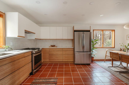D'Hanis Red Terracotta tile by Clay Imports covering a bright kitchen floor with white grout lines.
