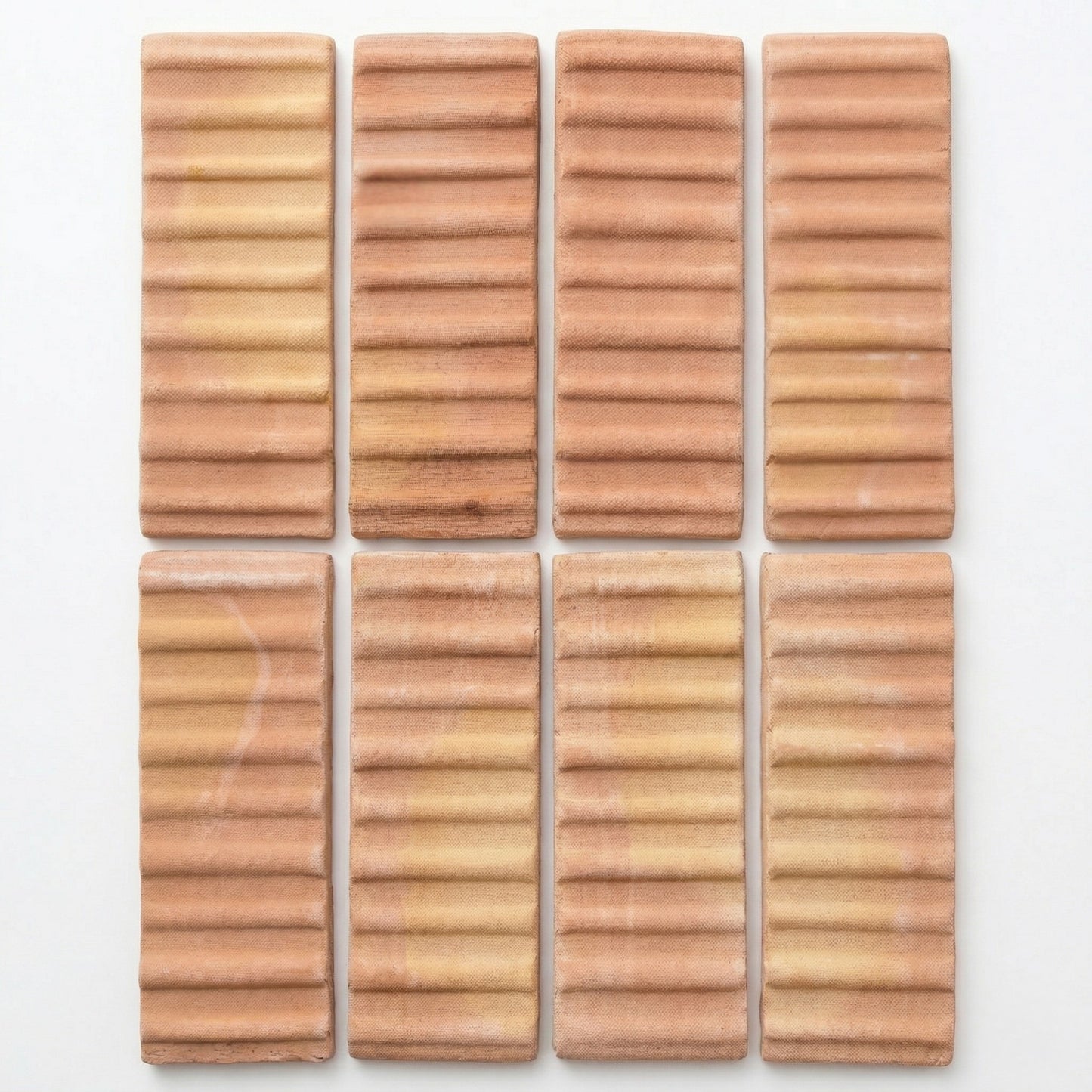 Bundle of 3D Hatch Terracotta Matte Sealed tiles by Clay Imports, with horizontal ribbed texture and varying terracotta shades, displayed in a grid.
