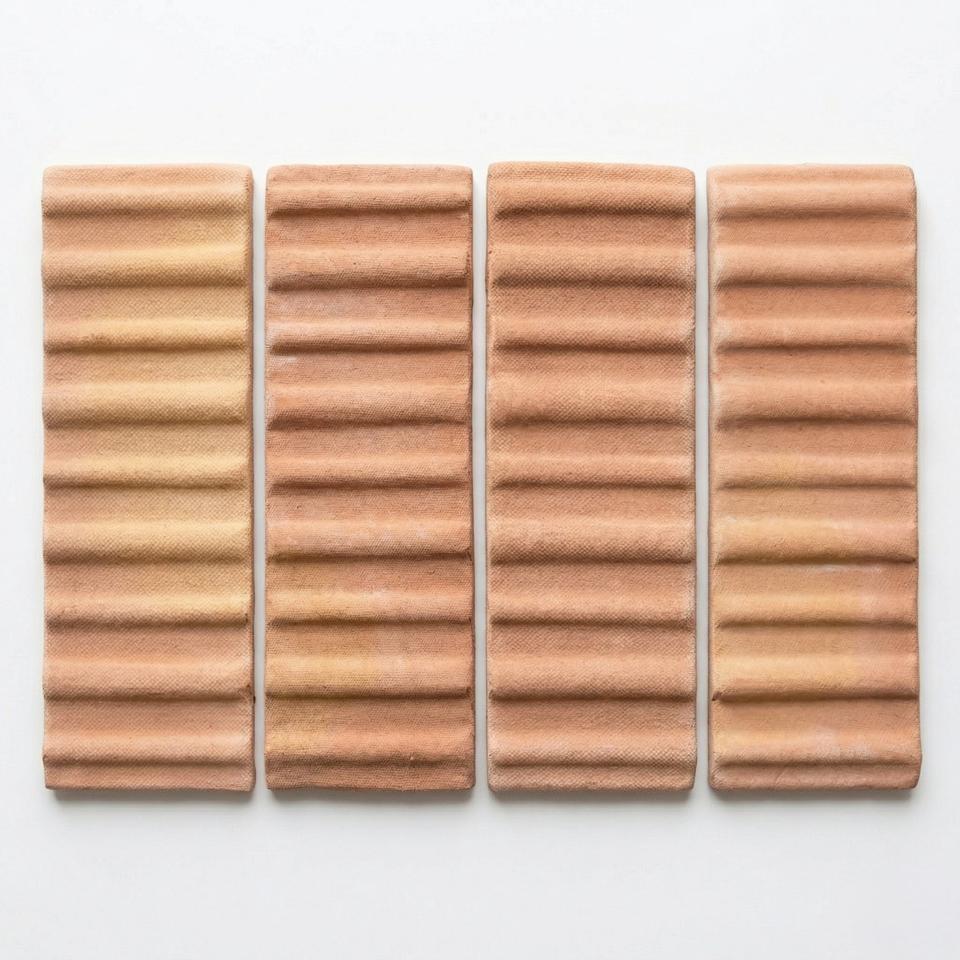 Four terracotta matte tiles by Clay Imports with a 3D corrugated hatch pattern and subtle texture.