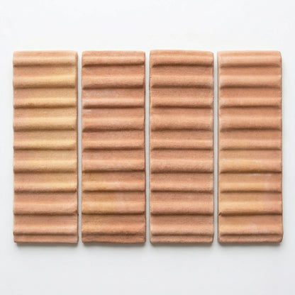 Four terracotta matte tiles by Clay Imports with a 3D corrugated hatch pattern and subtle texture.