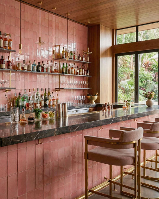 Hibiscus 3x6 clay tiles by Clay Imports covering a bar wall with a varied, handcrafted texture.