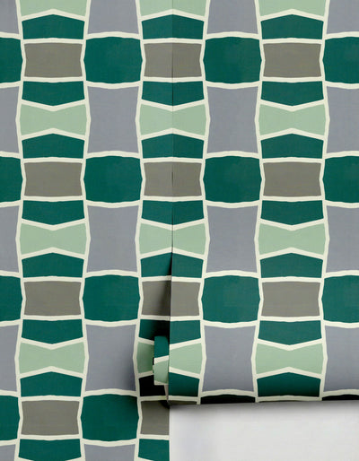 Geometric wallpaper in shades of green and grey by Clay Imports, with white outlines, partially unrolled.