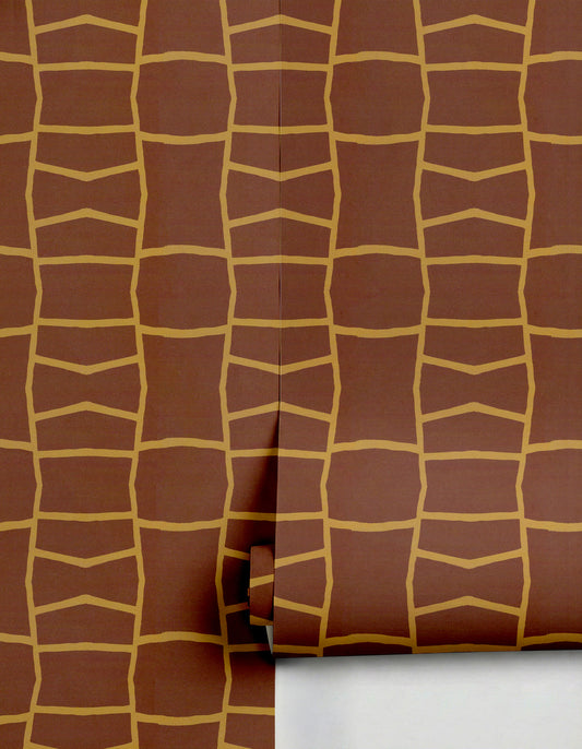 Brown and gold geometric wallpaper by Clay Imports, featuring an organic grid pattern, partially unrolled.