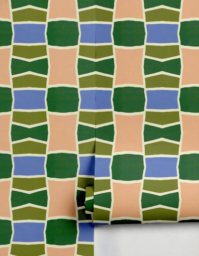 Green, blue, and peach geometric wallpaper by Clay Imports, partially unrolled.