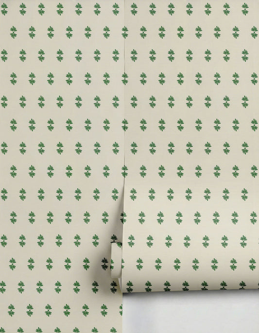 Cream wallpaper by Clay Imports with a repeating pattern of small dark green stylized flowers, partially unrolled.
