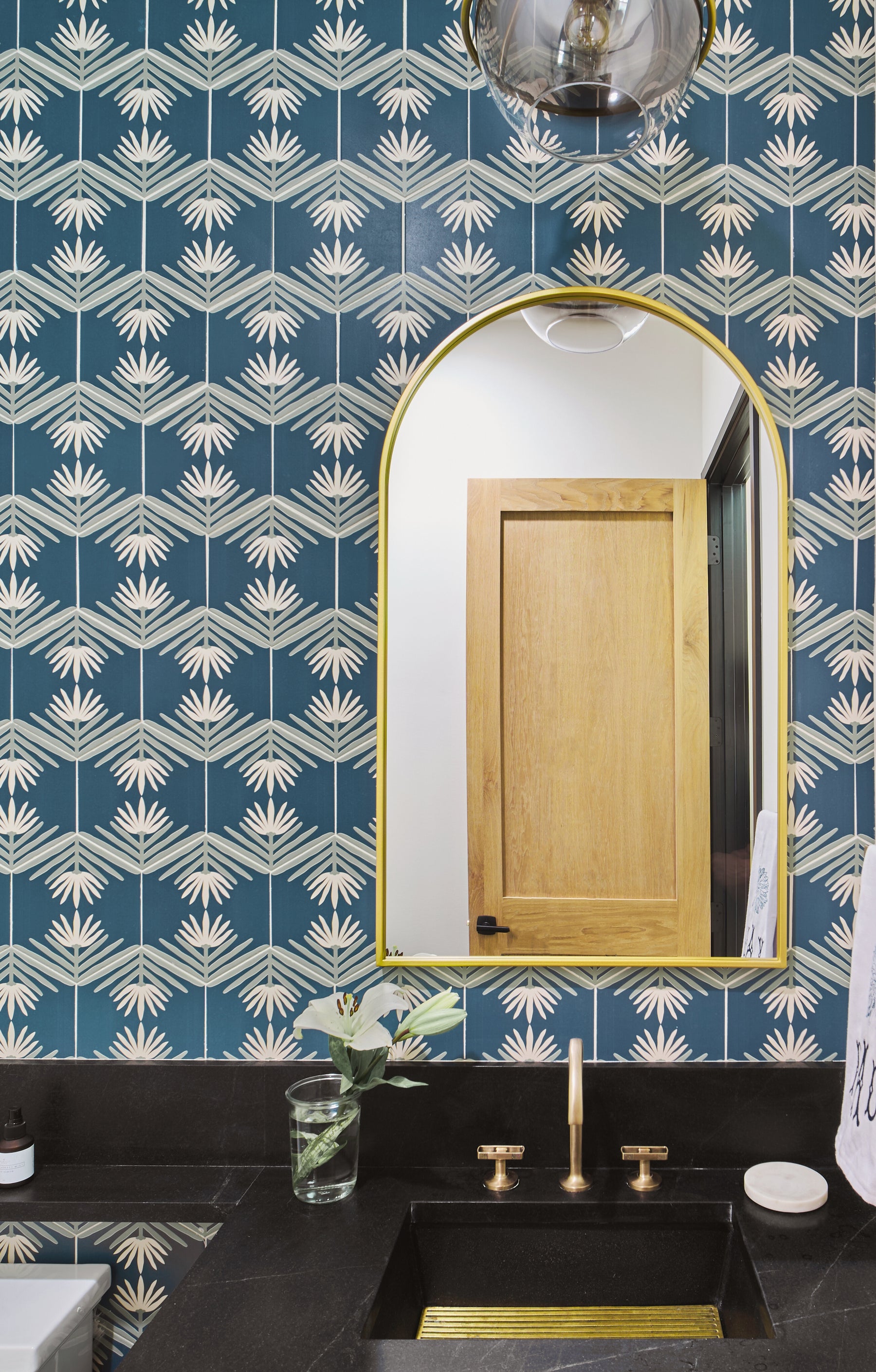 Blue floral hexagon tile in bathroom.