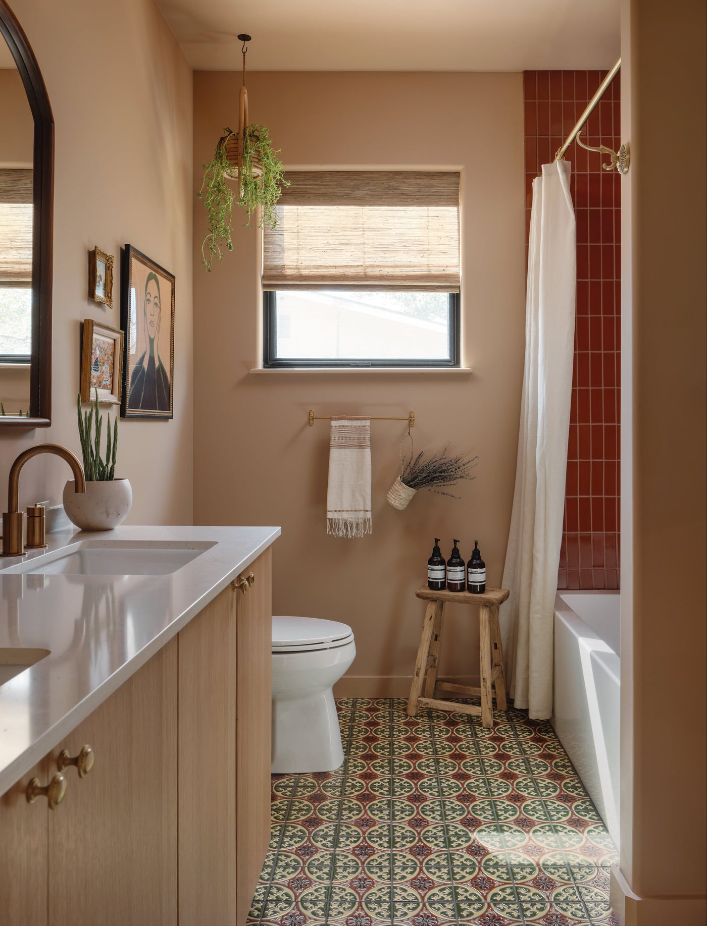 Green, cream, and red Relief Talavera tiles by Clay Imports featuring intricate circular and floral patterns on a bathroom floor.
