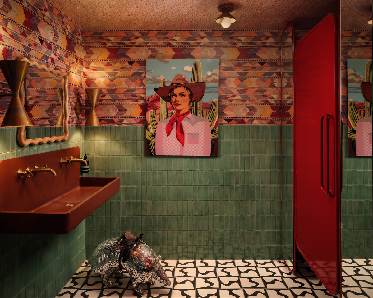 Black and white patterned square tiles by Clay Imports, featuring an abstract wavy design on a bathroom floor with green tiles and a disco armadillo.