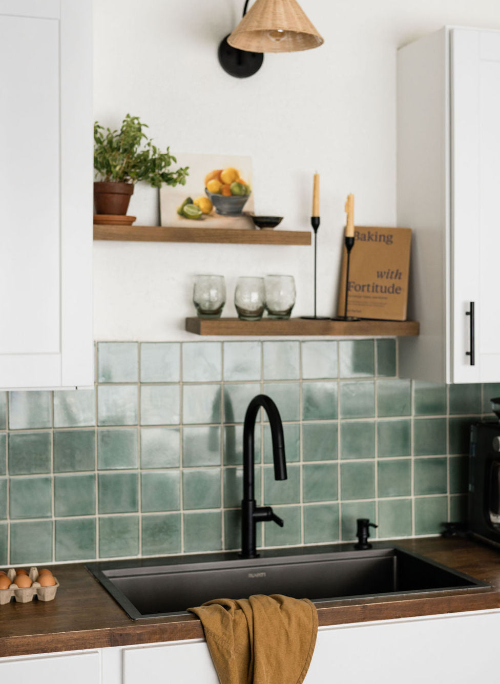 Square green solid tiles by Clay Imports with varied hues and a glossy finish, installed as a kitchen backsplash.