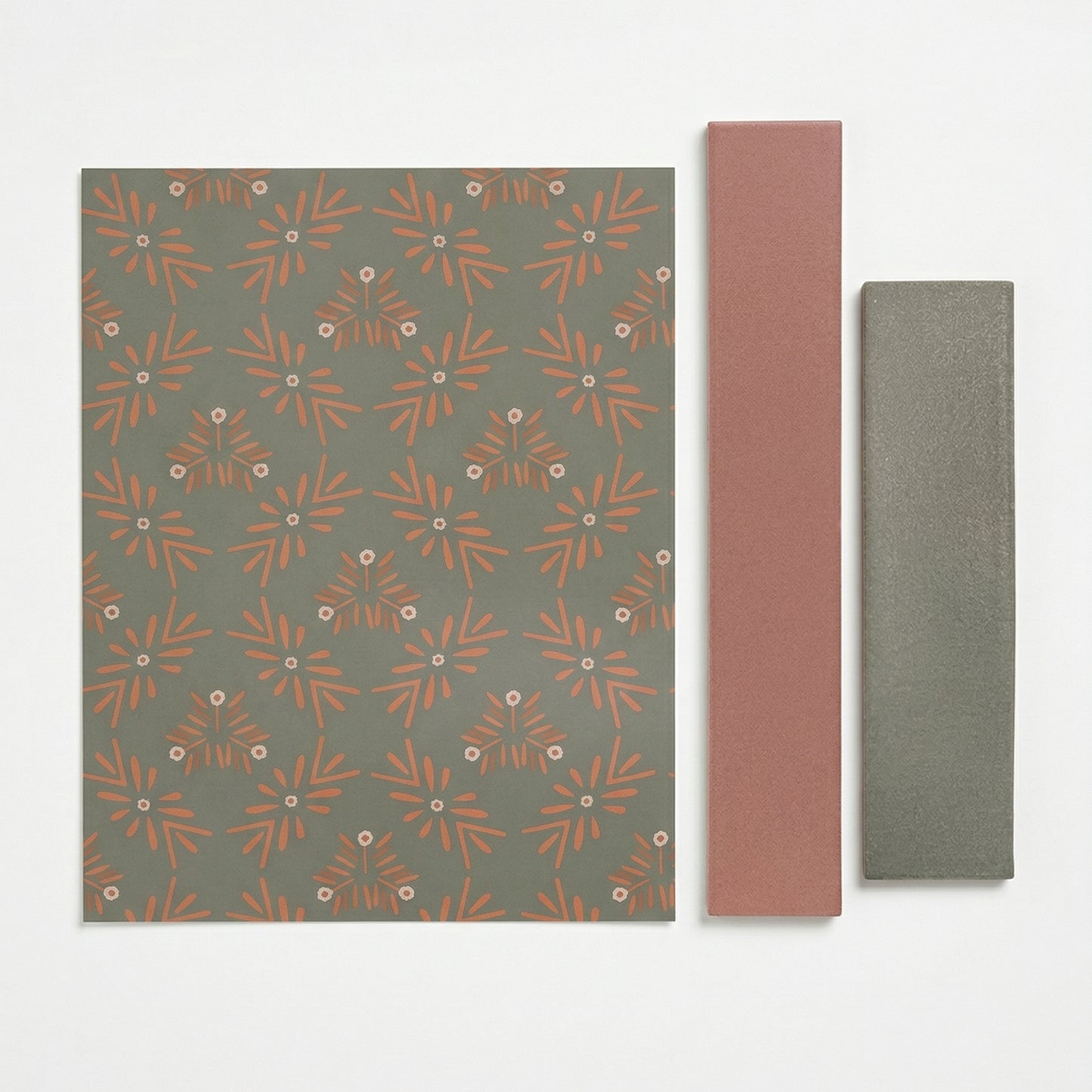 Olive Grove patterned tile sample by Clay Imports, featuring olive green with terracotta floral motifs, displayed with two coordinating solid tile samples.