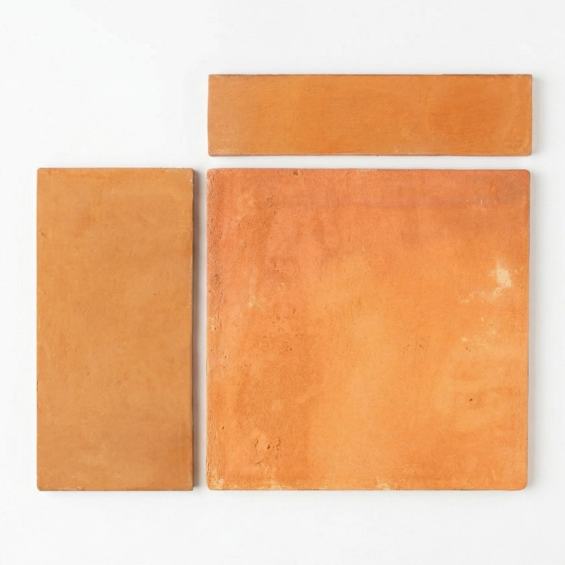 Organic terracotta samples by Clay Imports, three orange-brown pieces with rough texture in varying shapes on white.