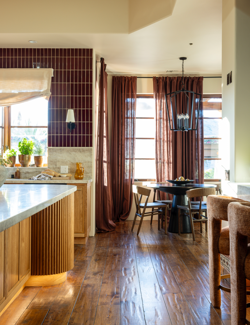 Oxblood 2x8 clay tiles by Clay Imports installed vertically as a kitchen backsplash, forming a neat grid.