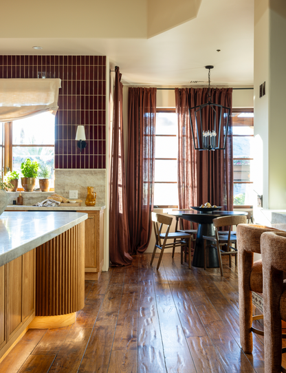 Oxblood 2x8 clay tiles by Clay Imports installed vertically as a kitchen backsplash, forming a neat grid.