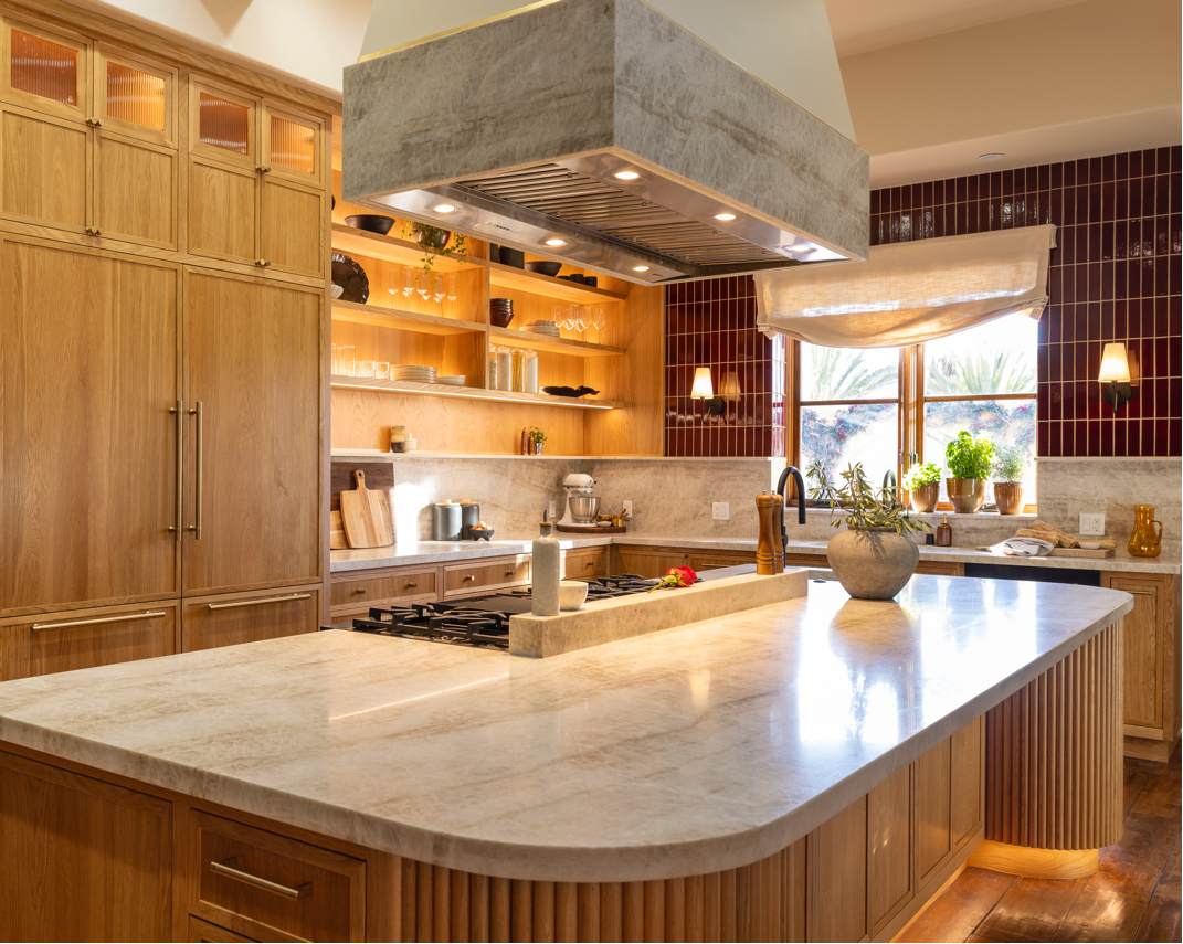 Oxblood red 2x8 clay tiles from Clay Imports, installed vertically as a glossy kitchen backsplash.