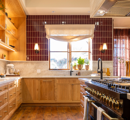 Oxblood red rectangular clay tiles by Clay Imports, installed as a glossy, vertically stacked kitchen backsplash.