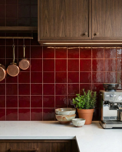 Oxblood 6x6 clay tiles by Clay Imports, featuring a glossy, deep red finish as a kitchen backsplash.
