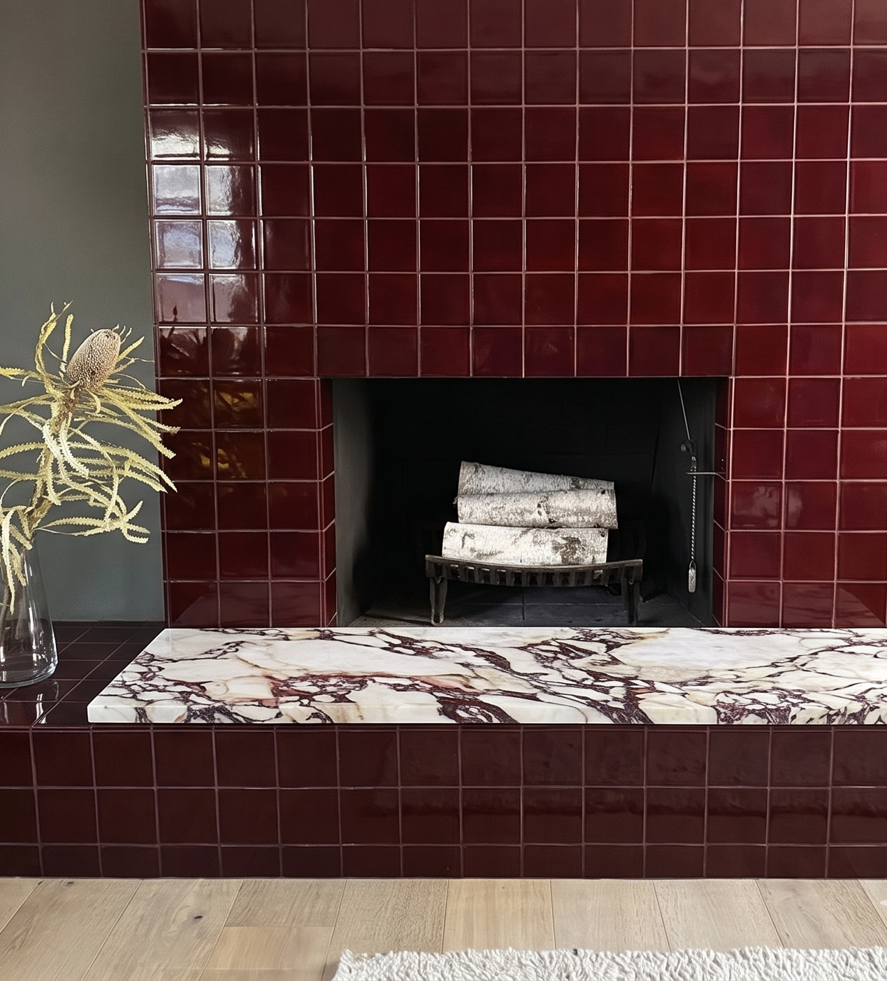 Oxblood 4.25x4.25 inch square clay tiles by Clay Imports on a modern fireplace and hearth with a marble top.