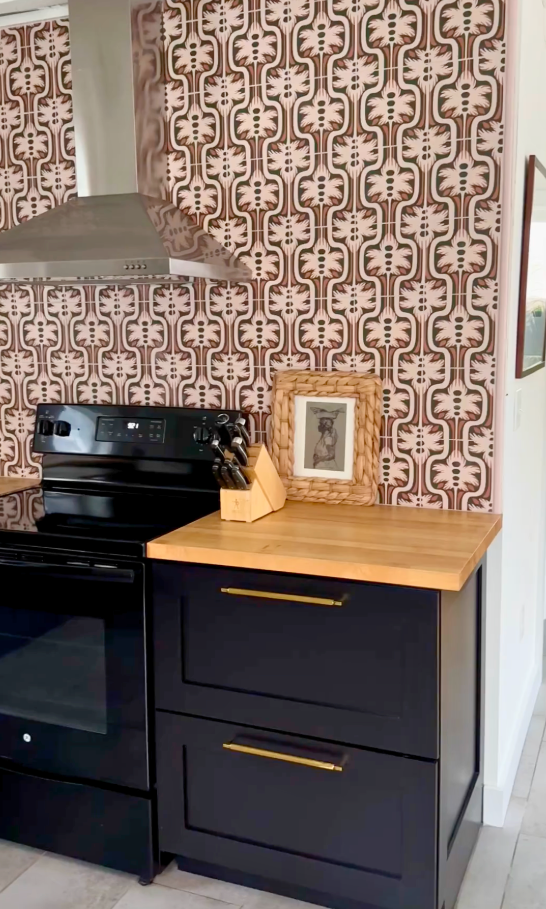 Palmetto Crepe pattern tile by Clay Imports, featuring repeating brown, cream, and dark organic motifs as a kitchen backsplash.