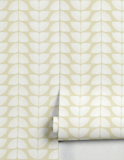 Pale yellow wallpaper with a white petal pattern by Clay Imports, unrolled to show the repeating motif.
