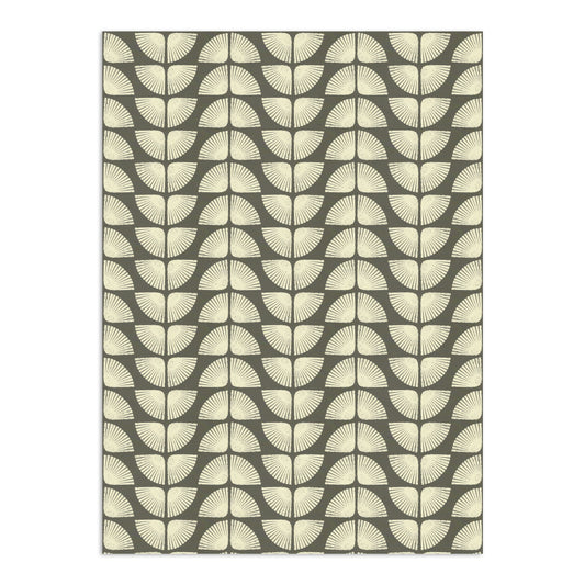 Light beige Petalita Wallpaper by Clay Imports with a distressed geometric fan pattern on a dark gray background.