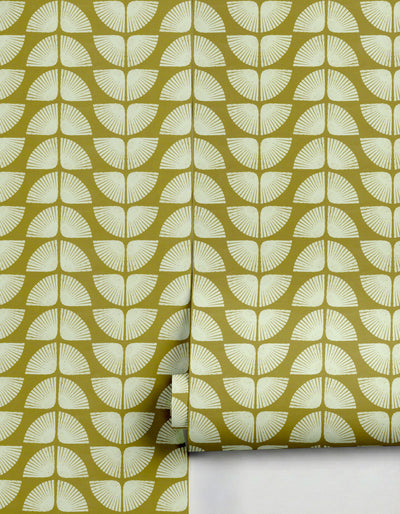 Olive green Petalita wallpaper by Clay Imports featuring an off-white geometric fan pattern, partially unrolled.