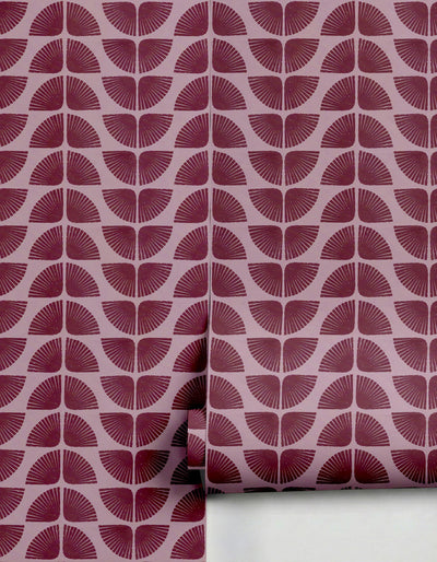 Burgundy Petalita Wallpaper by Clay Imports featuring a repeating fanned half-circle pattern on a light pink background, with a roll visible.