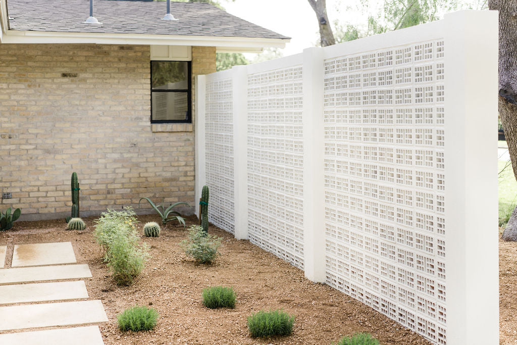 White Breeze Block by Clay Imports Breeze Blocks, displaying a geometric pixel pattern as a modern garden wall.