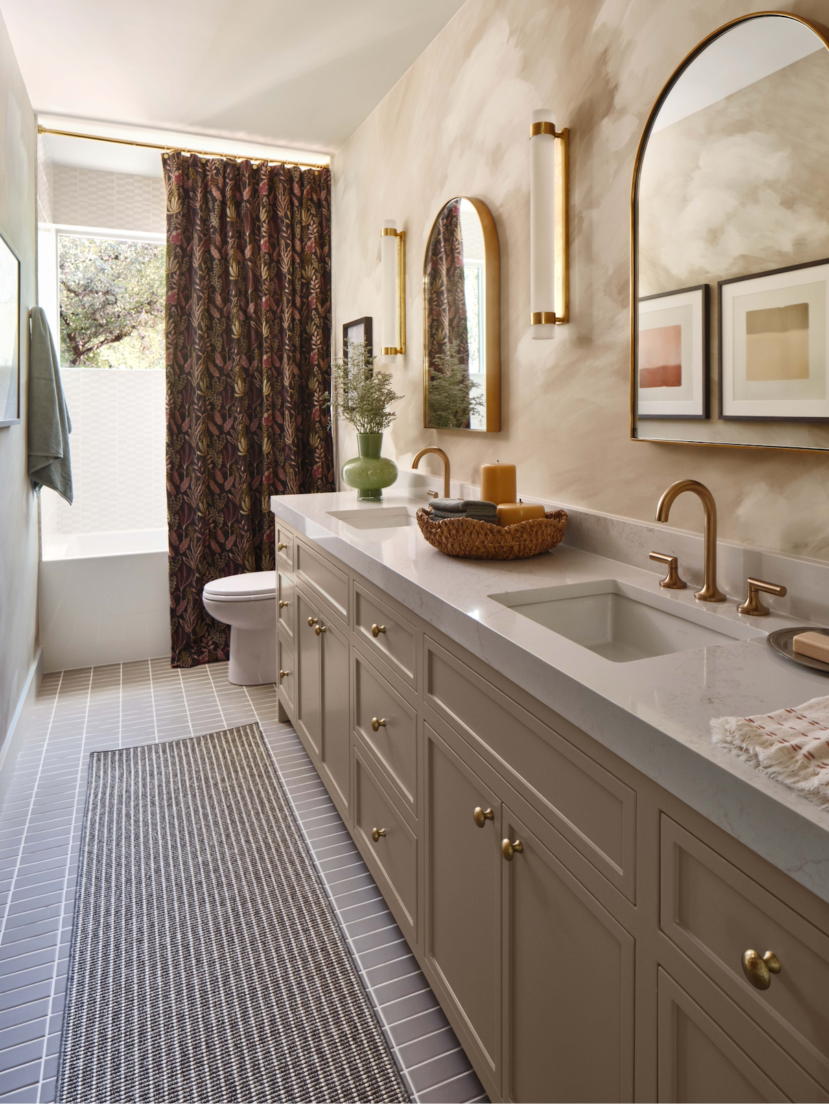 Plata Matte 2x5 solid tile by Clay Imports in light gray on a bathroom floor with a striped rug.