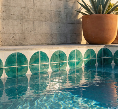 Jade Quarter Circle pool waterline pattern tile by Clay Imports, featuring green circles reflecting in blue water.