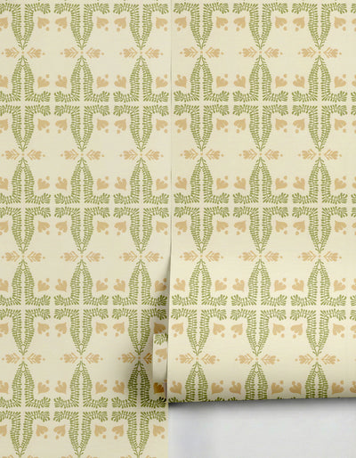 Green and beige botanical wallpaper by Clay Imports, featuring a repeating fern and flower pattern, partially unrolled.