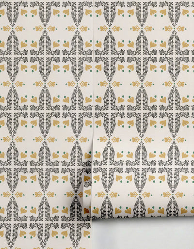 Spring wallpaper by Clay Imports featuring a repeating pattern of dark grey-green foliage and mustard yellow floral shapes on a cream background, partially unrolled.