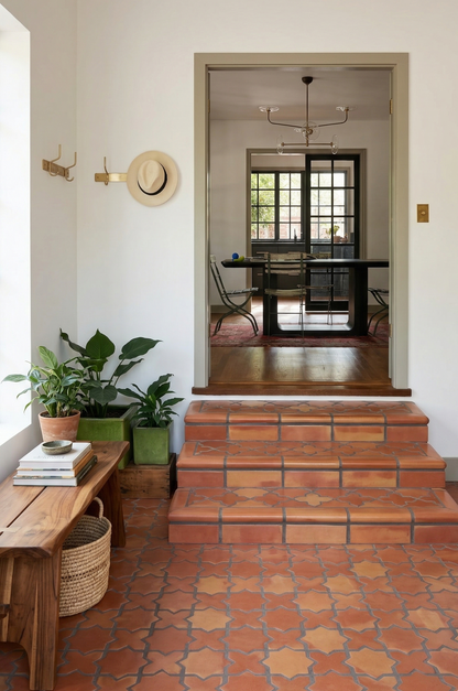 Terracotta Star & Cross Smooth Satin tiles by Clay Imports, in warm reddish-brown with dark grout, covering a floor and stairs in an entryway.
